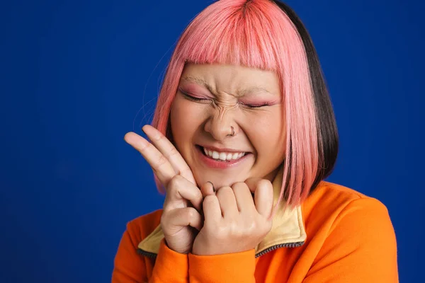 亚洲女孩 一头粉红的头发笑着 在蓝色的背景下表现出和平的姿态 — 图库照片