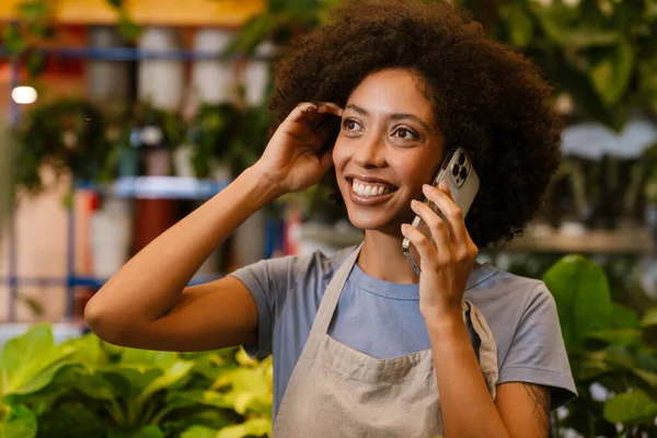 Happy Young Florist Girl Using Cellphone While Working Potted Plants — Stock Photo, Image