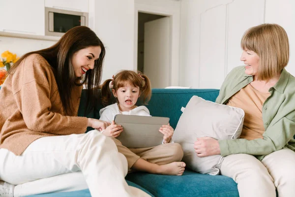 白人女孩在家里与家人呆在一起时使用平板电脑 — 图库照片