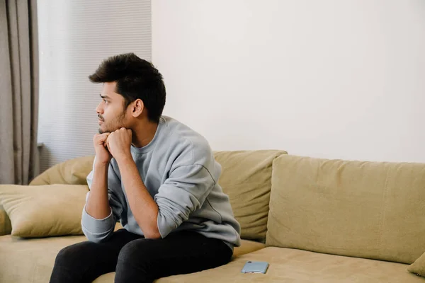 Young Thoughtful Indian Man Sitting Sofa Thinking Home — Stock Photo, Image