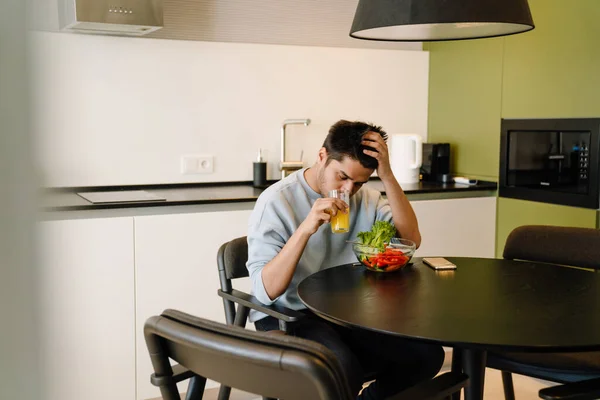 Young Indian Man Propping His Head His Hand Sitting Kitchen — Stock Photo, Image