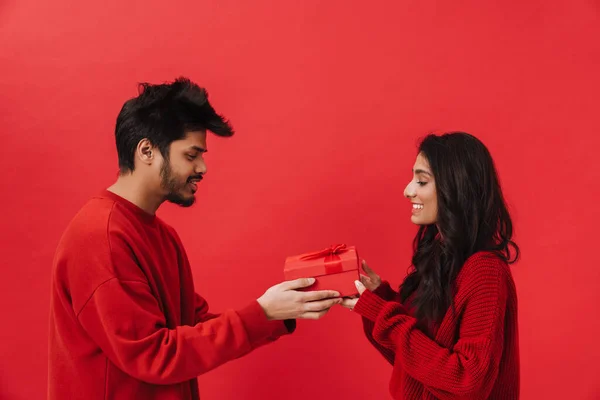 Young Indian Man Giving Present Box His Girlfriend Isolated Red — Stock Photo, Image