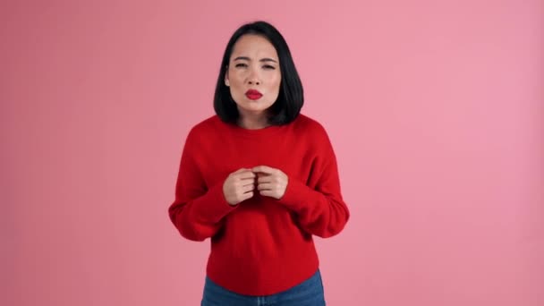 Smiling Asian Woman Wearing Red Sweater Looking Camera Pink Studio — Stock Video