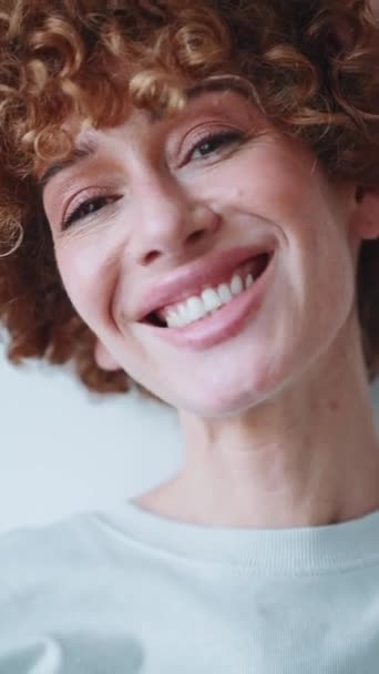 Curly Haired Smiling Woman Looking Camera Grey Studio — Stock Video