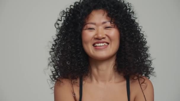 Portrait Cheerful Brunette Asian Woman Looking Camera Grey Studio — Vídeos de Stock