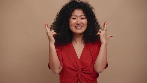 Pretty Curly Haired Asian Woman Hoping Something Beige Studio — Stock Video