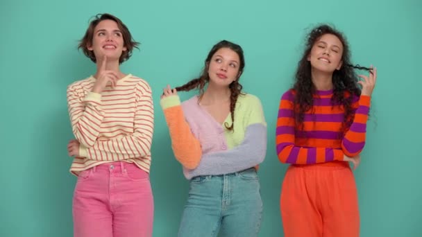 Three Positive Young Girls Thinking Something Turquoise Studio — Vídeo de stock