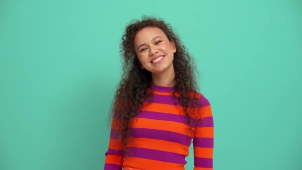 Cheerful Young Curly Haired Woman Waving Hand Camera Turquoise Studio — Vídeos de Stock