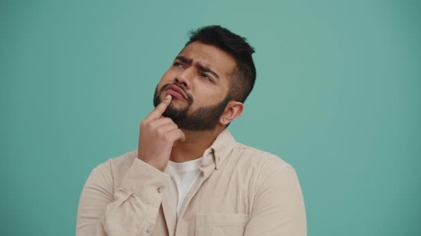 Concentrated Middle Eastern Young Man Thinking Something Turquoise Studio — Vídeos de Stock