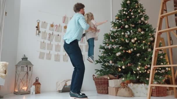 Pretty Father Puts His Daughter His Neck Christmas Tree Home — Vídeos de Stock