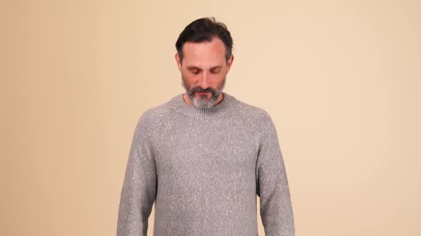 Smiling Adult Bearded Man Wearing Grey Sweater Looking Camera Beige — Stock Video