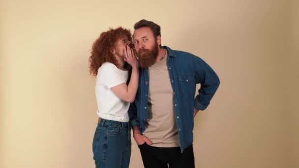 Happy Redhaired Woman Tells Secret Her Boyfriend Ear Beige Studio — Stock videók