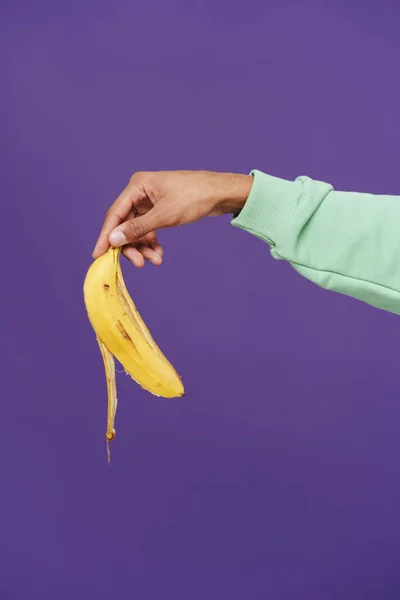 Male Hand Holding Banana Peel Cropped Close Isolated Violet Background — Stockfoto