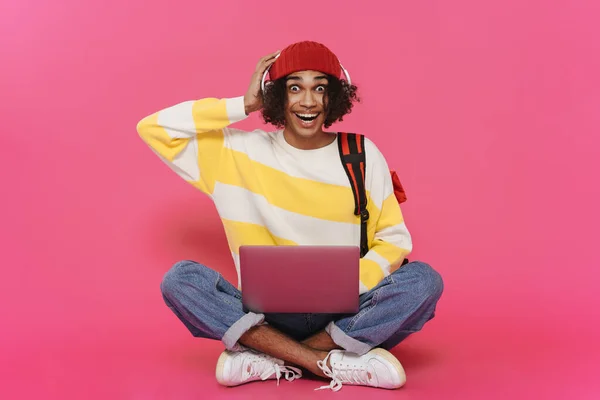 Young Caribbean Man Headphones Laughing Using Laptop Isolated Pink Background — 图库照片