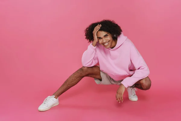 Young Caribbean Man Piercing Smiling Squatting Isolated Pink Background — 图库照片