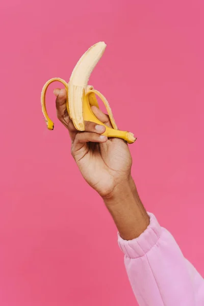 Black Man Hand Holding Showing Banana Camera Isolated Pink Background — Stockfoto
