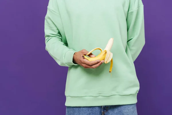 Young Caribbean Man Holding Showing Banana Camera Isolated Purple Background — Zdjęcie stockowe