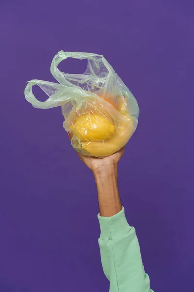 Black Man Hand Holding Plastic Bag Fruits Isolated Purple Background — Stock Photo, Image