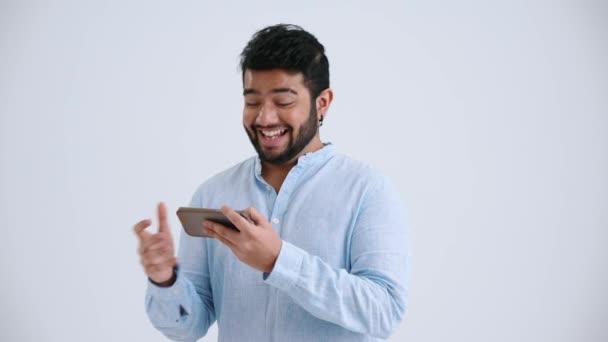 Happy Indian Man Piercing Wearing Blue Shirt Playing Game Phone — Stockvideo