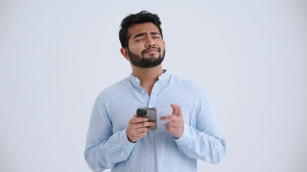 Pensive Indian Man Piercing Wearing Blue Shirt Typing Phone Grey — Stock video