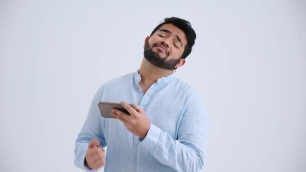 Sad Indian Man Piercing Wearing Blue Shirt Playing Game Phone — Stock Video