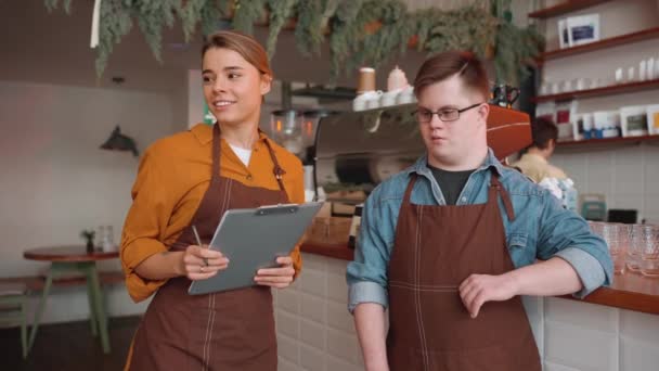 Confident Male Waiter Syndrome Talking Girl Colleague Cafe — Vídeos de Stock