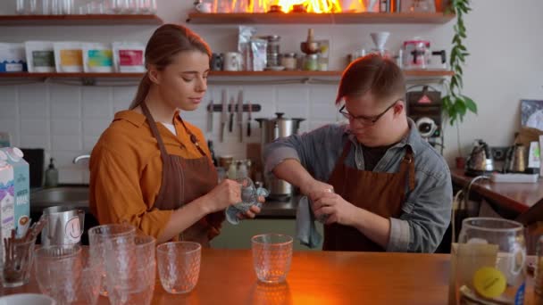 Serious Man Barista Syndrome Wiping Glasses His Girl Colleague Cafe — Stockvideo