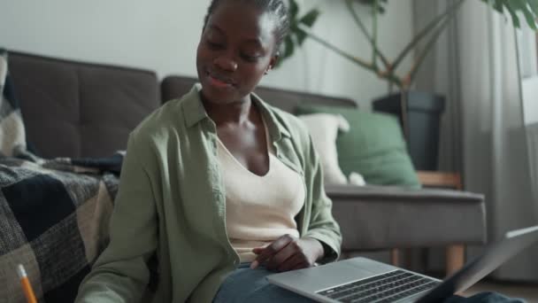 Happy African Woman Pigtails Writing Something Laptop Notepad While Sitting — Stockvideo