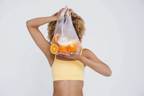 Young Black Woman Wearing Underclothes Holding Bag Fruits Isolated White — Stock Photo, Image