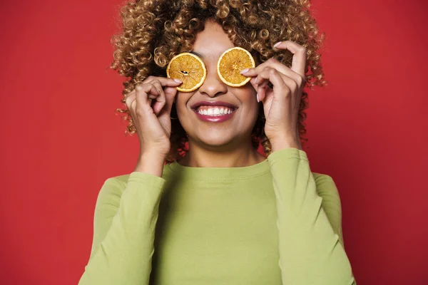 Young Black Woman Laughing While Making Fun Orange Isolated Red — стоковое фото