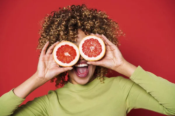 Young Black Woman Afro Curls Having Fun Holding Orange Cut — стоковое фото