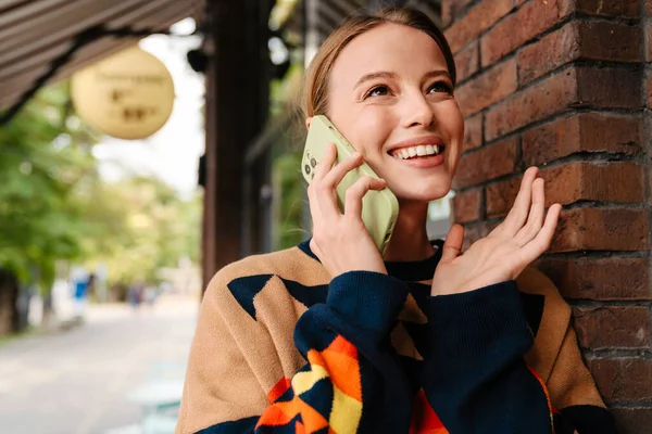 Pretty Joyful Woman Colorful Sweater Talking Mobile Phone Gesturing While — Photo