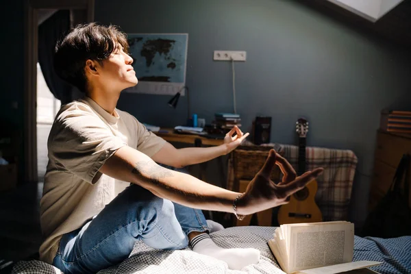 Jovem Asiático Homem Vestindo Shirt Meditando Enquanto Lendo Livro Cama — Fotografia de Stock