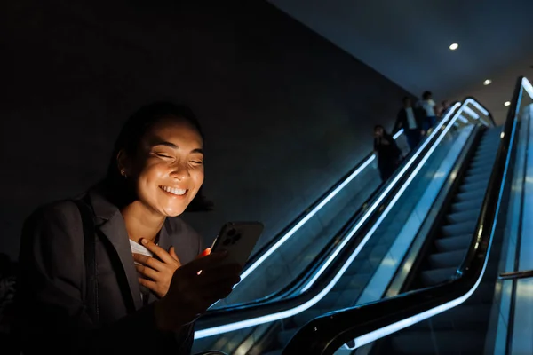 Genç Güzel Asyalı Bir Kadın Akıllı Telefon Kullanıyor Yürüyen Merdivende — Stok fotoğraf