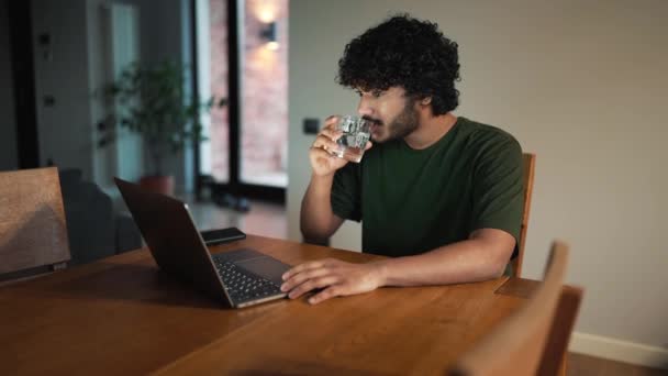 Handsome Curly Haired Indian Man Working Laptop Drinking Glass Water — Stock video