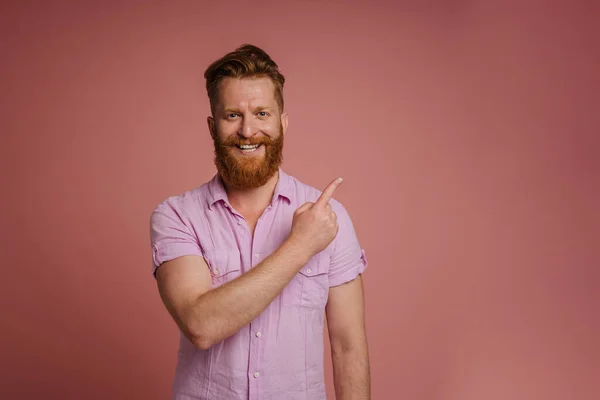 Adult Handsome Stylish Redhead Bearded Smiling Man Pointing Aside Looking — Stockfoto