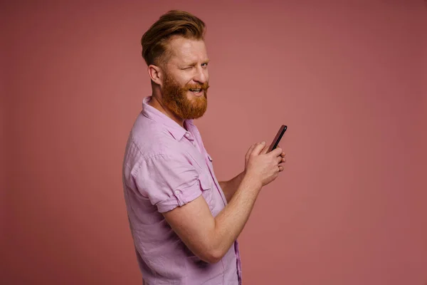 Adult Stylish Handsome Redhead Bearded Smiling Winking Man Holding Phone — 图库照片