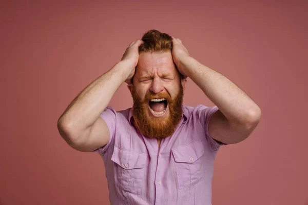 Adult Stressed Redhead Bearded Man Closed Eyes Pink Shirt Holding — Stockfoto