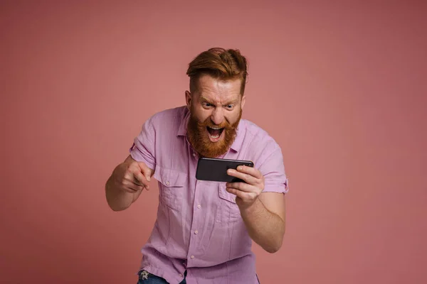 Adult Stylish Redhead Bearded Enthusiastic Man Shouting Holding Phone Celebrating — Stockfoto