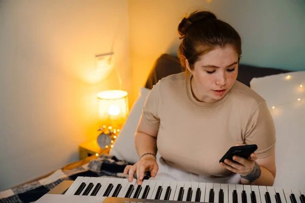 Young Beautiful Focused Girl Playing Electronic Piano Watching Video Lesson — Stock Photo, Image