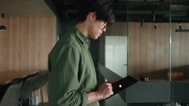 Serieuze Brunet Aziatische Man Met Bril Werkend Tablet Tijdens Het — Stockvideo