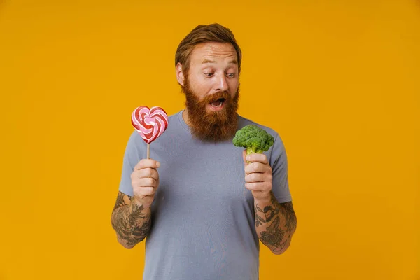 Bearded Man Holding Lollipop Broccoli While Standing Isolated Yellow Background — Stock Photo, Image