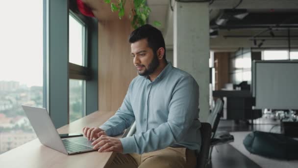 Pensive Indian Man Working Laptop Window Office — Stock Video