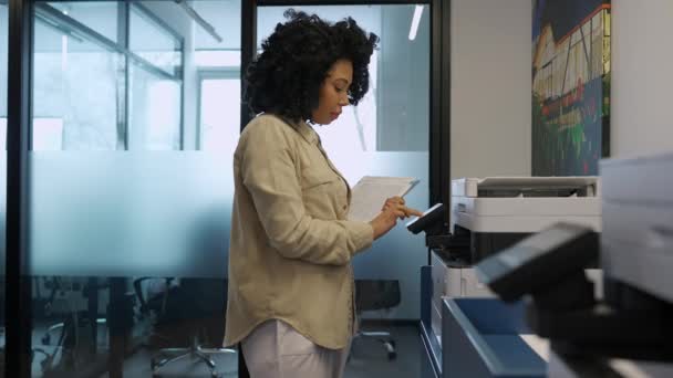 集中アフリカの巻き女性オフィスでプリンタ上の文書を印刷 — ストック動画