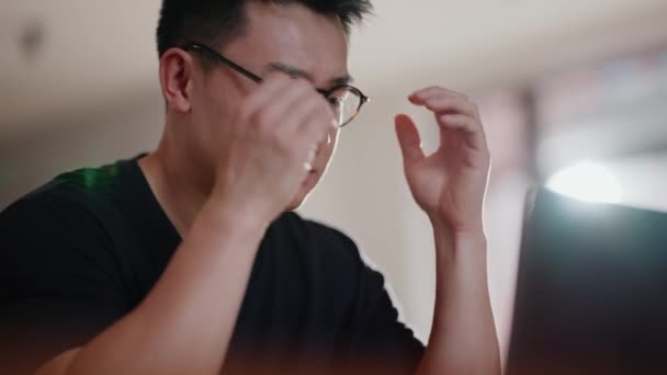 Displeased Asian Man Eyeglasses Working Laptop Home — Stock Video