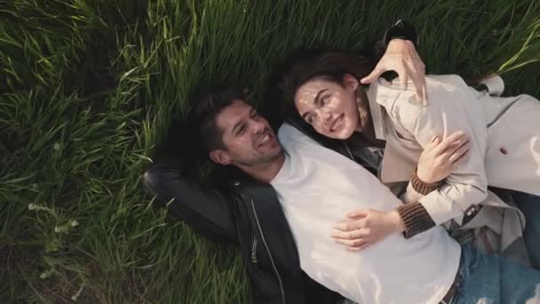 Cheerful Couple Talking Hugging While Lying Picnic Blanket Field Sea — Stock Video
