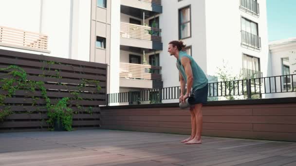Smiling Curly Haired Man Spreads Out Yoga Mat Hotel Balcony — Vídeos de Stock