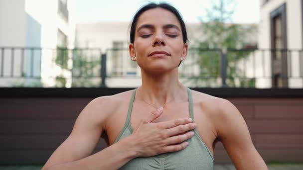Pretty Brunette Woman Meditating While Doing Breathing Exercises Looking Camera — стокове відео