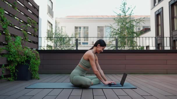 Cheerful Brunette Woman Texting Laptop Meditating While Sitting Yoga Mat — стокове відео