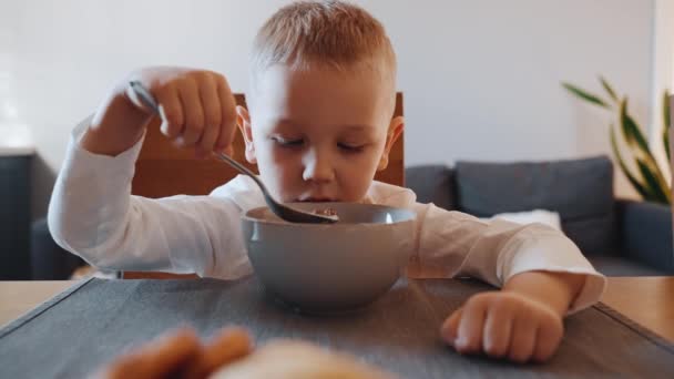 Concentrated Blond Little Boy Have Breakfast Kitchen Home — Stock Video